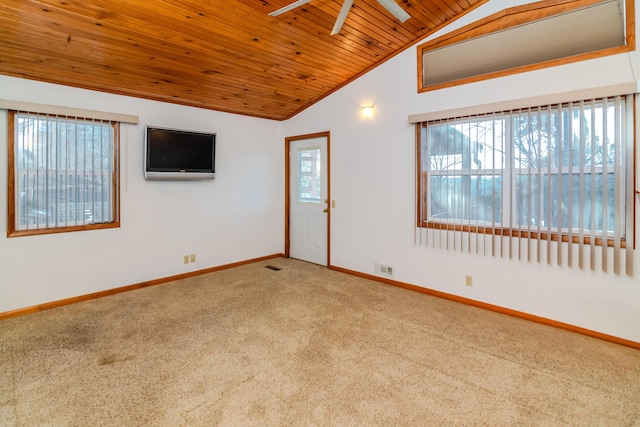 carpeted empty room with lofted ceiling, ceiling fan, plenty of natural light, and wood ceiling