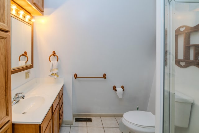 bathroom featuring toilet, vanity, and tile patterned floors