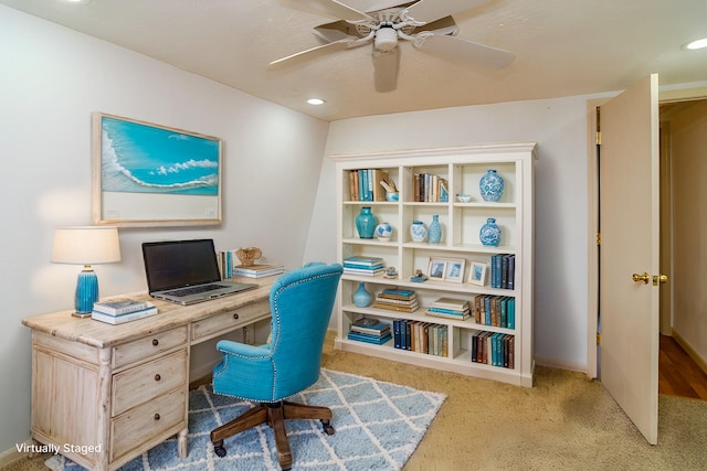 carpeted home office with ceiling fan