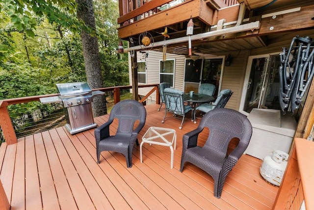 wooden terrace featuring a grill