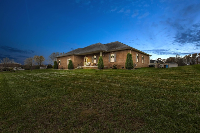 property exterior at dusk featuring a yard