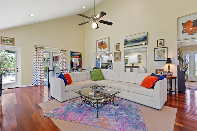 living room with wood-type flooring, high vaulted ceiling, and ceiling fan