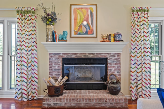 room details featuring a fireplace and wood-type flooring