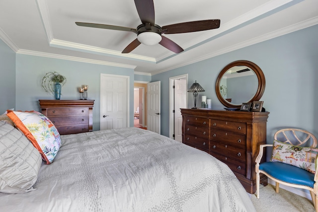 carpeted bedroom featuring ceiling fan, a raised ceiling, and crown molding