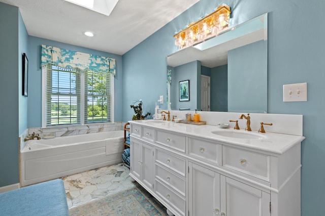 bathroom featuring tile patterned flooring, vanity, a tub to relax in, and a skylight