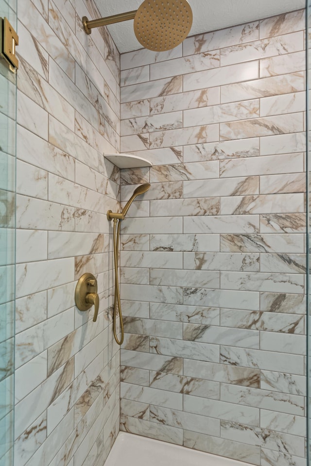 bathroom with tiled shower