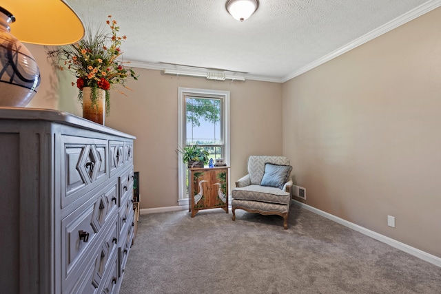 sitting room with a textured ceiling, carpet floors, and ornamental molding