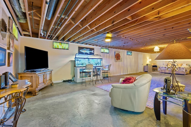 living room with concrete floors and wood walls