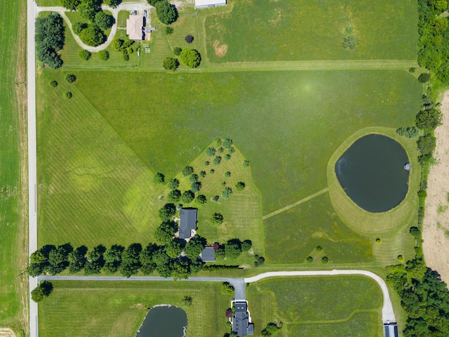 birds eye view of property featuring a water view and a rural view