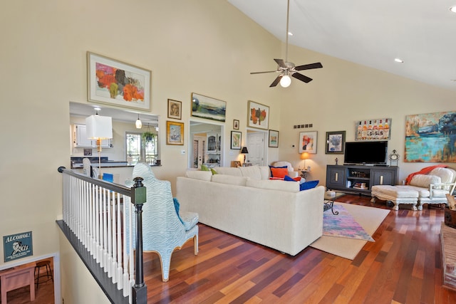 living room with hardwood / wood-style floors, high vaulted ceiling, and ceiling fan