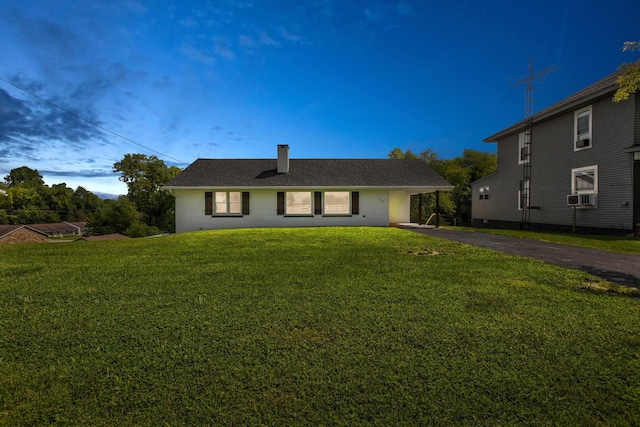 view of front of house featuring cooling unit and a front lawn