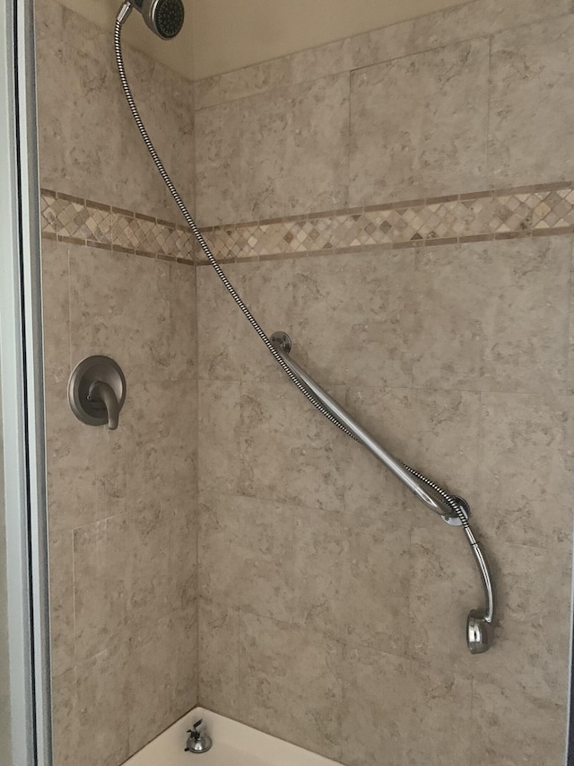 bathroom with tiled shower