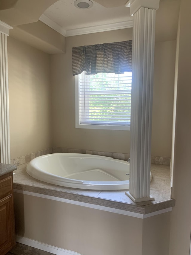 bathroom featuring vanity, a bathtub, and crown molding