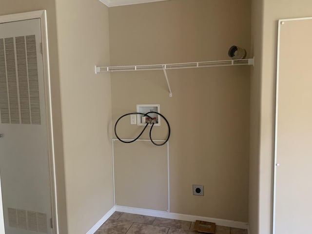 laundry room featuring electric dryer hookup, light tile patterned floors, and washer hookup