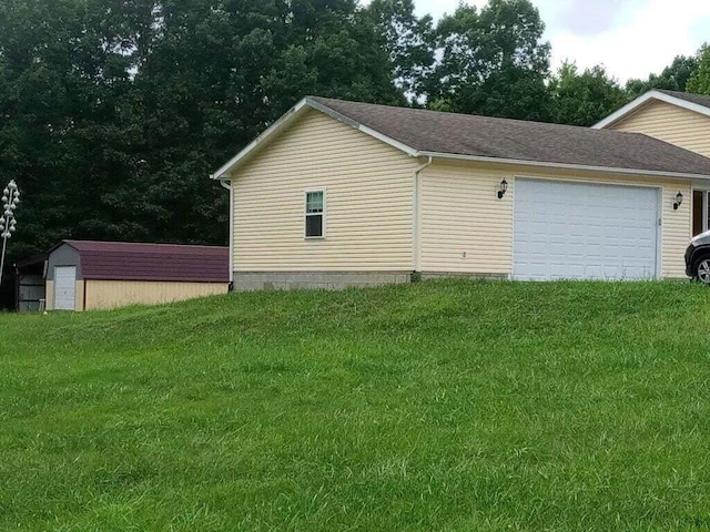 view of side of property with a lawn and a garage