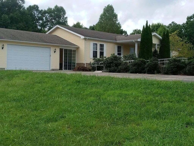 ranch-style home featuring a front yard and a garage