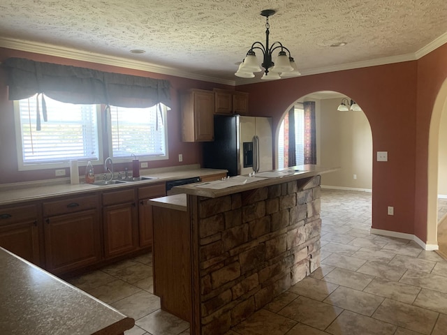 kitchen featuring pendant lighting, an inviting chandelier, sink, stainless steel refrigerator with ice dispenser, and a kitchen island