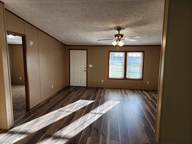 interior space with ceiling fan, dark hardwood / wood-style flooring, and a textured ceiling