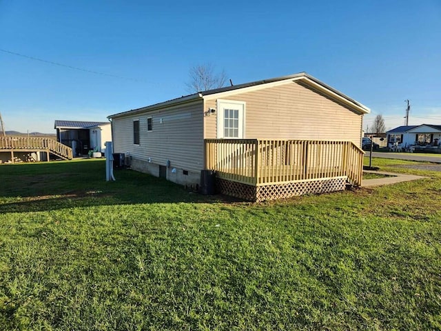 view of property exterior with a yard and a deck