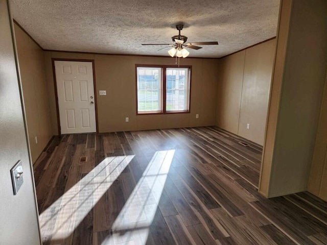 interior space featuring a textured ceiling, dark hardwood / wood-style flooring, ceiling fan, and crown molding