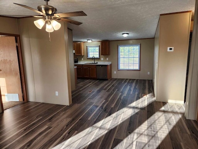 kitchen with dark hardwood / wood-style flooring, stainless steel dishwasher, a textured ceiling, ceiling fan, and sink