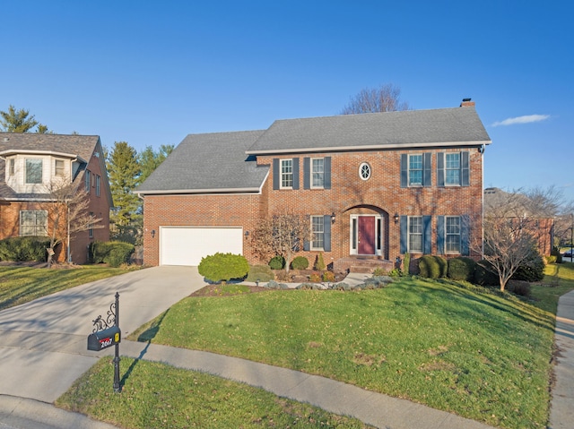 colonial home featuring a garage and a front yard