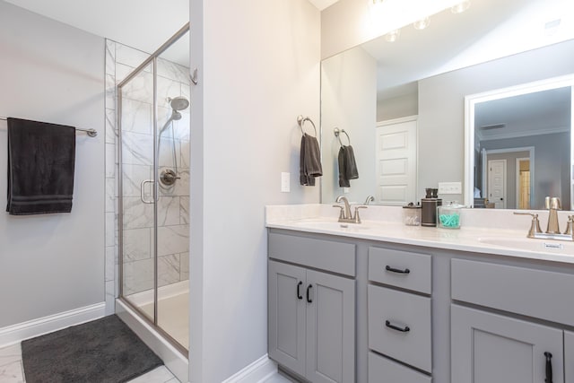 bathroom featuring vanity, a shower with shower door, and ornamental molding