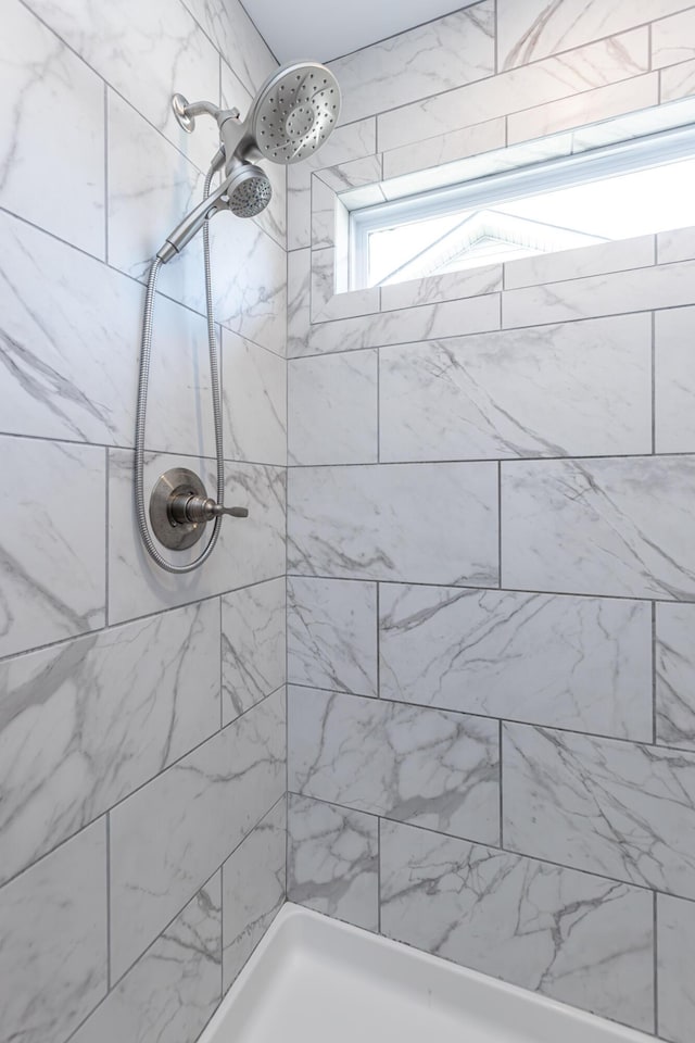 bathroom with tiled shower