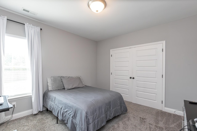 carpeted bedroom featuring a closet