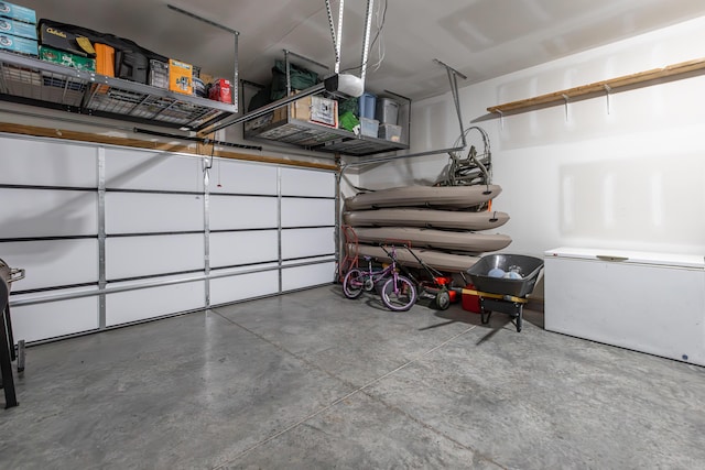 garage featuring a garage door opener and fridge