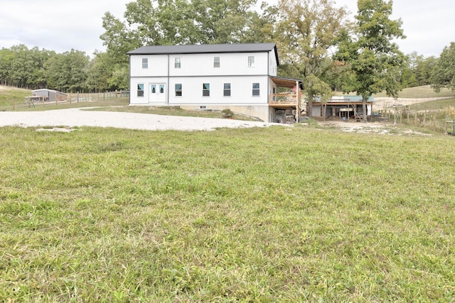 rear view of property with a yard and a rural view