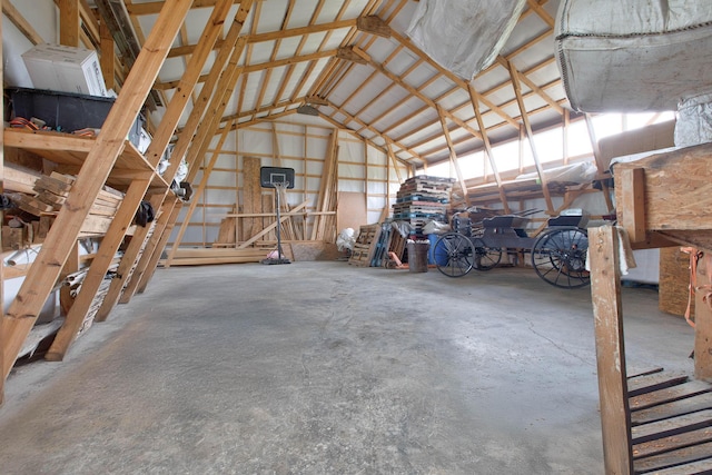 misc room featuring concrete flooring and high vaulted ceiling