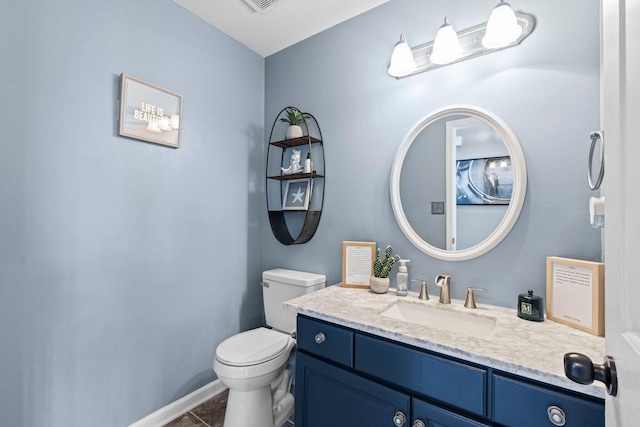 bathroom featuring vanity and toilet