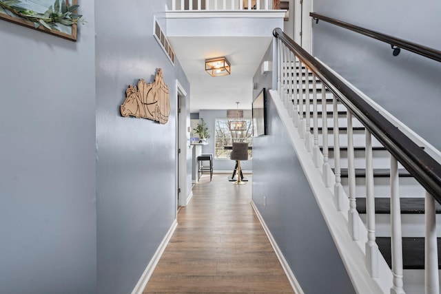 hall with hardwood / wood-style flooring