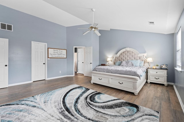 bedroom with ceiling fan, dark wood-type flooring, and high vaulted ceiling