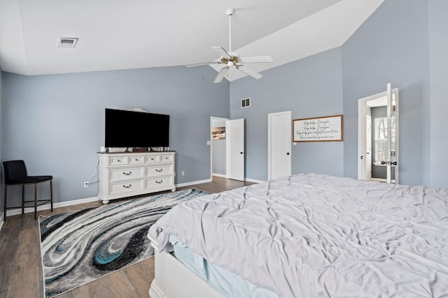 bedroom with ceiling fan, dark wood-type flooring, and high vaulted ceiling