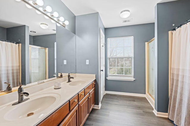 bathroom featuring vanity, a shower, and hardwood / wood-style floors