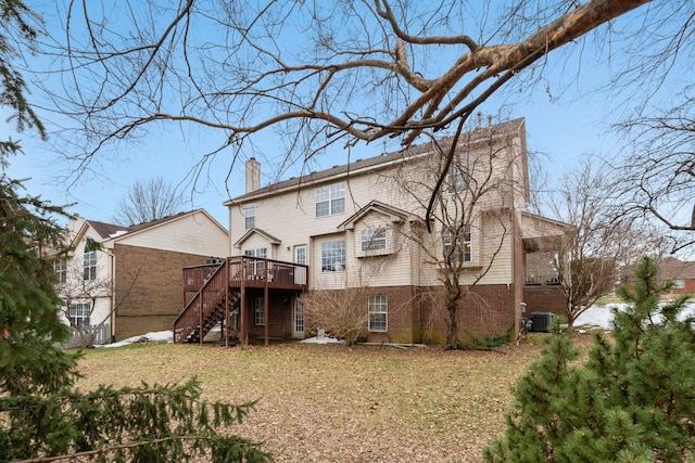 rear view of house with cooling unit, a yard, and a wooden deck