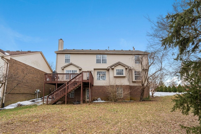 back of house featuring a lawn and a deck