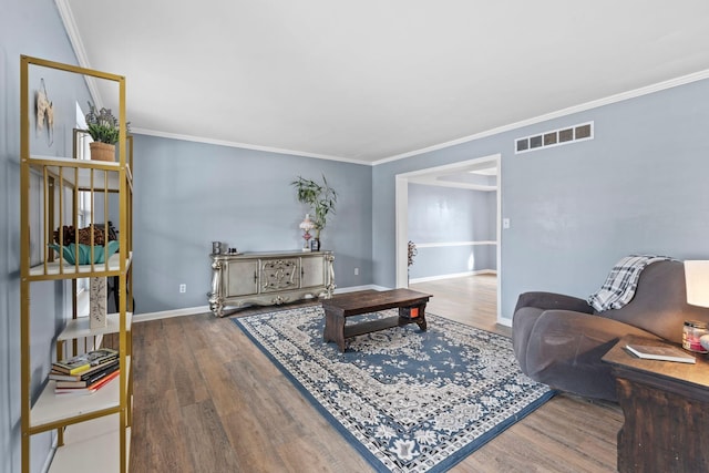 living room featuring crown molding and hardwood / wood-style floors