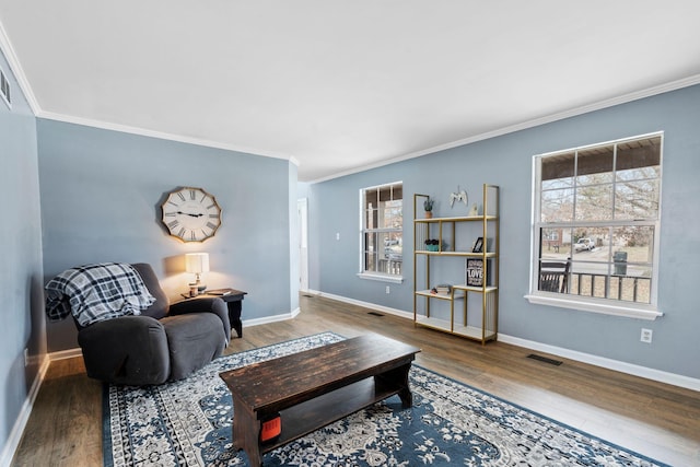 living room featuring crown molding, plenty of natural light, and wood-type flooring