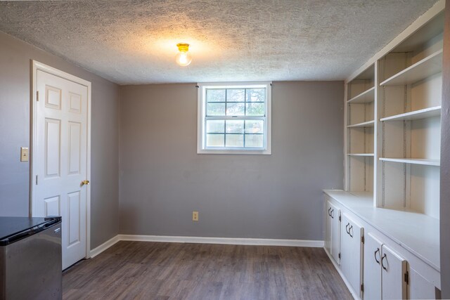 interior space with ceiling fan, hardwood / wood-style floors, and a textured ceiling