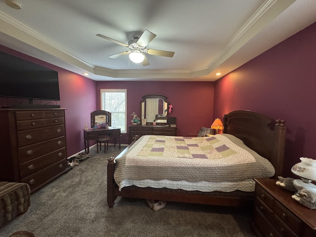 bedroom with carpet floors, a tray ceiling, crown molding, a ceiling fan, and baseboards