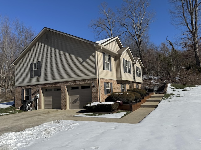 view of snow covered exterior featuring a garage