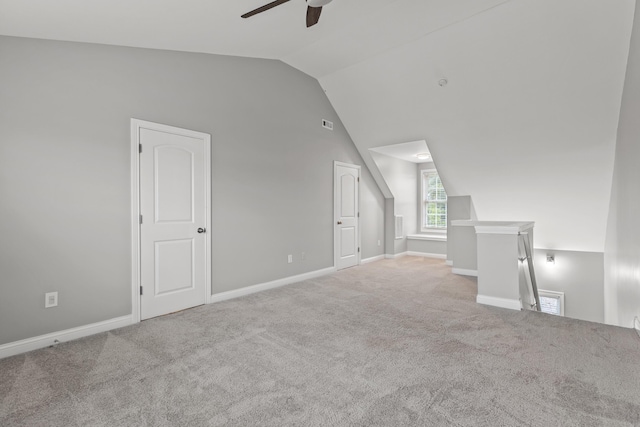 additional living space featuring ceiling fan, light colored carpet, and vaulted ceiling