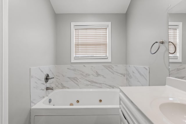 bathroom featuring a tub to relax in and vanity