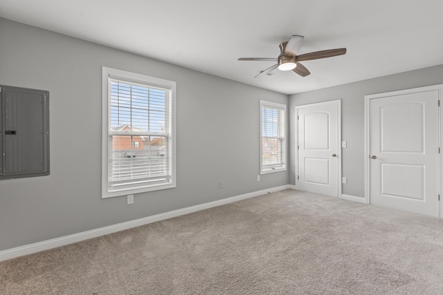 unfurnished bedroom featuring carpet flooring, ceiling fan, and electric panel