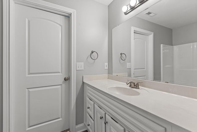 bathroom with a shower and vanity