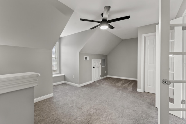 bonus room featuring ceiling fan, light carpet, and lofted ceiling