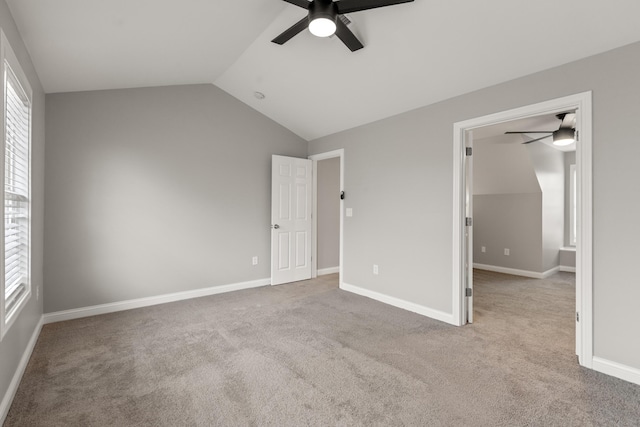 unfurnished bedroom with ceiling fan, light colored carpet, and lofted ceiling